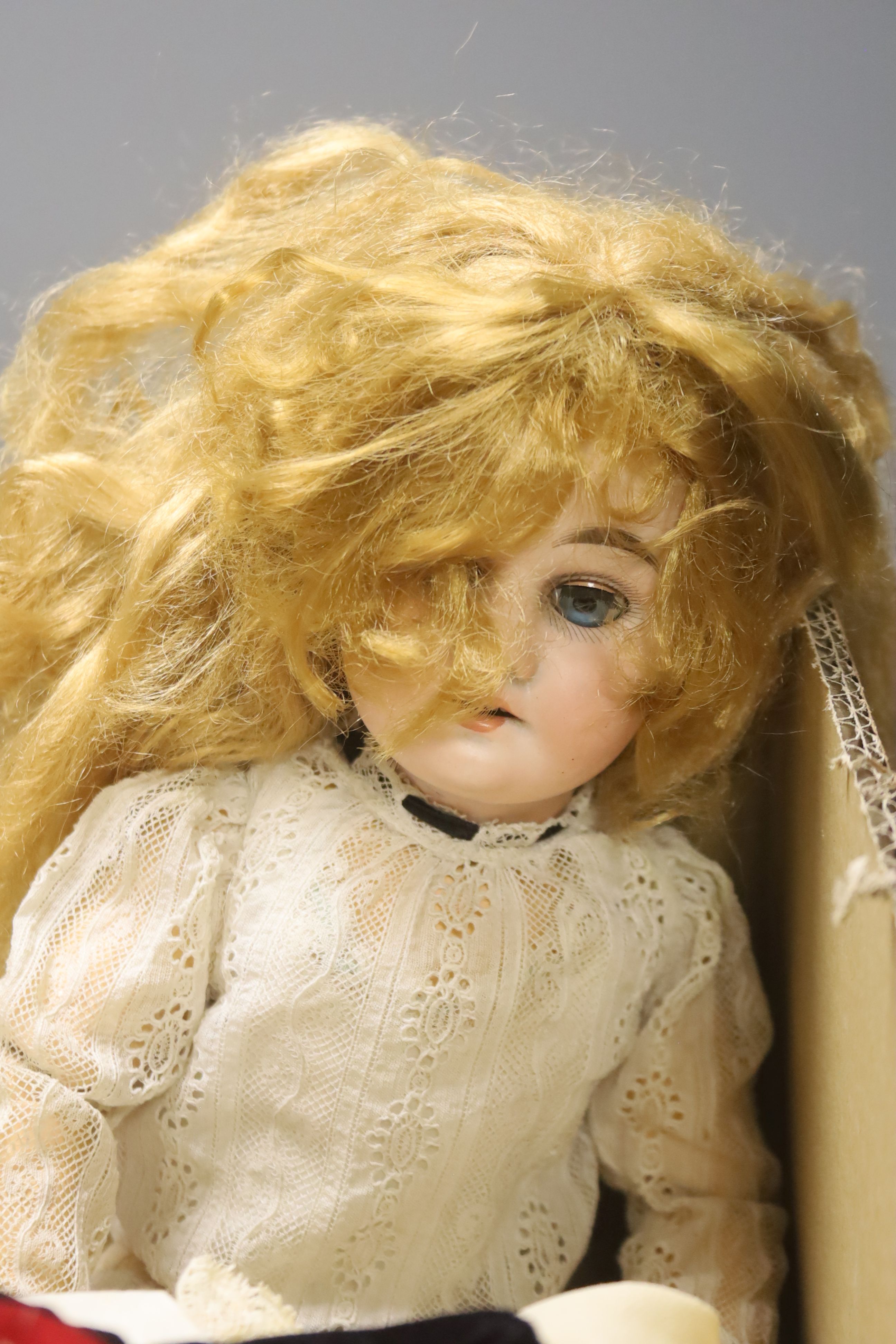 An Armand Marseille doll, an Ernst Heubach doll and a quantity of dolls' clothing, etc.